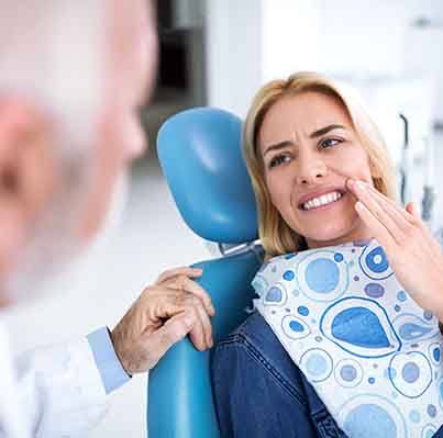 Woman in the dentist’s chair with tooth pain