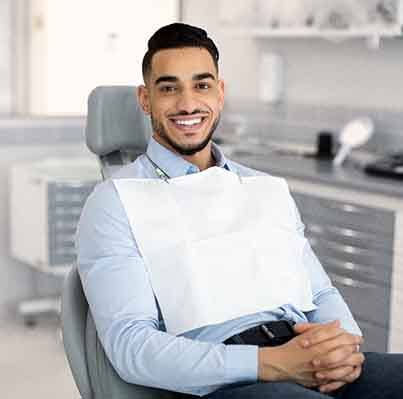 Man smiling while seated in the dentist’s chair