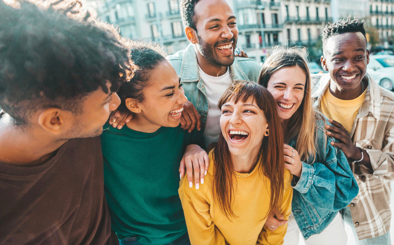 Patient out with friends and smiling with dental implants